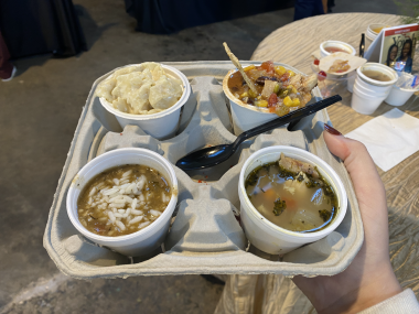 four varieties of soup on a drink holder