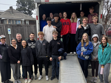 college students post for photo with moving truck