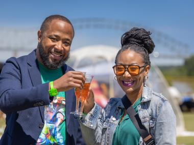 couple cheers glasses if mimosas