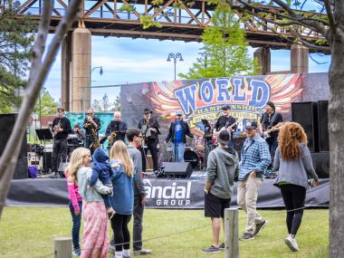 music stage set up at hot wing festival with crowd watching band performing
