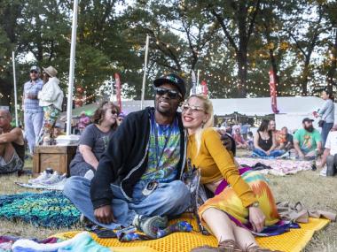 A couple sits on a blanket, enjoying a performance at Mempho Music Fest.