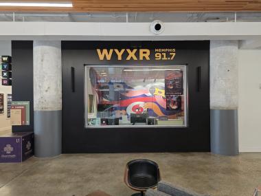 exterior of WYXR radio booth in crosstown concourse that is visible to the public