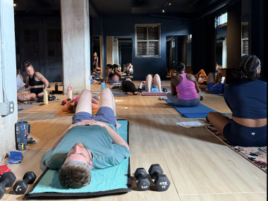 people rest on mats before pilates class