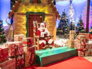 Santa's Wonderland at Bass Pro Shops at the Pyramid with Santa sitting in his chair surrounded by presents.