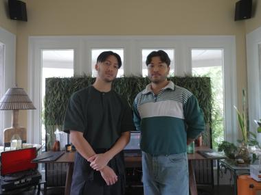 photo of two filipino men standing side by side looking into the camera with straight faces