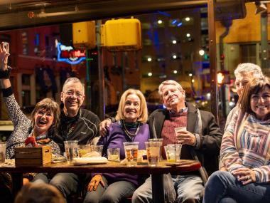 group of friends sitting and have drinks and smiling