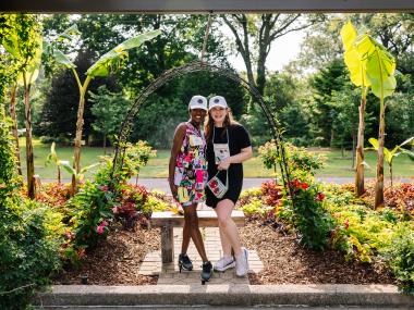 two women pose for photo in garden